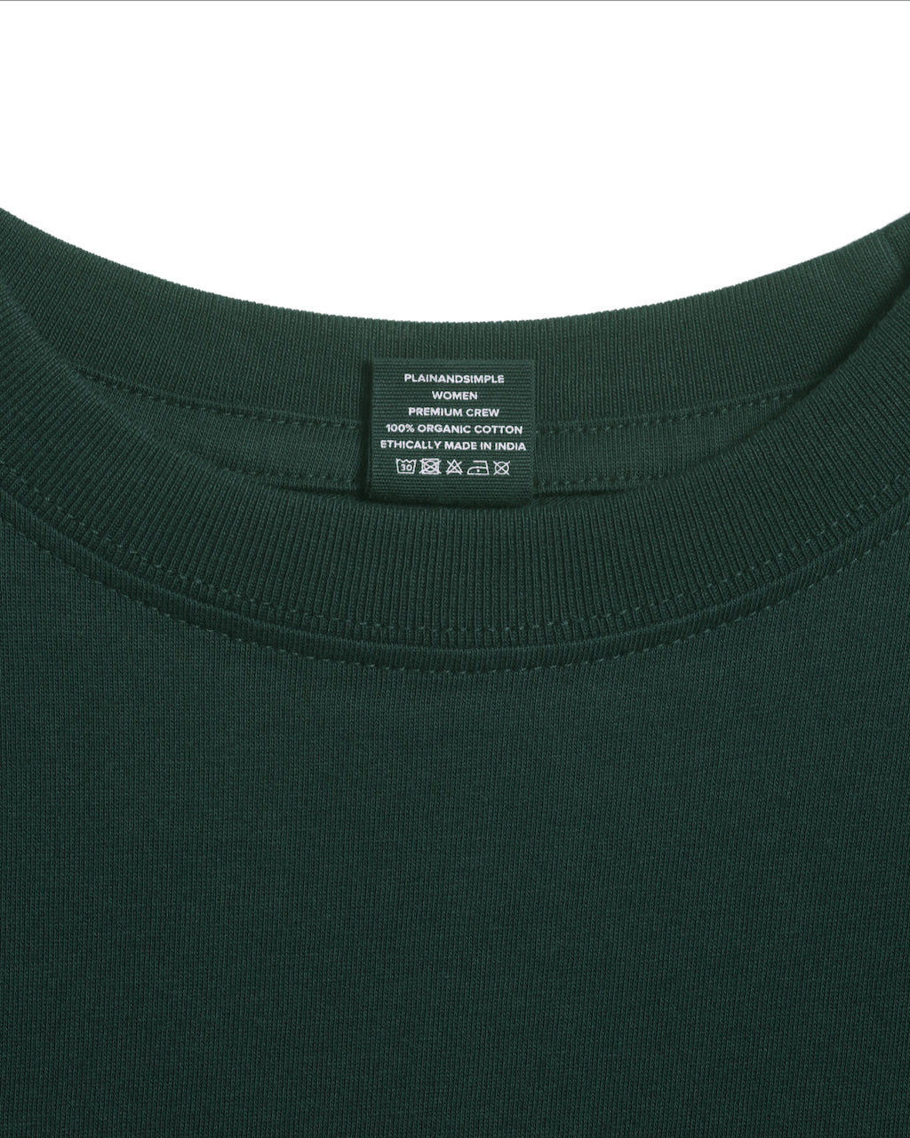 A close up of an neck label in a women's green short sleeve crew neck organic cotton t shirt.