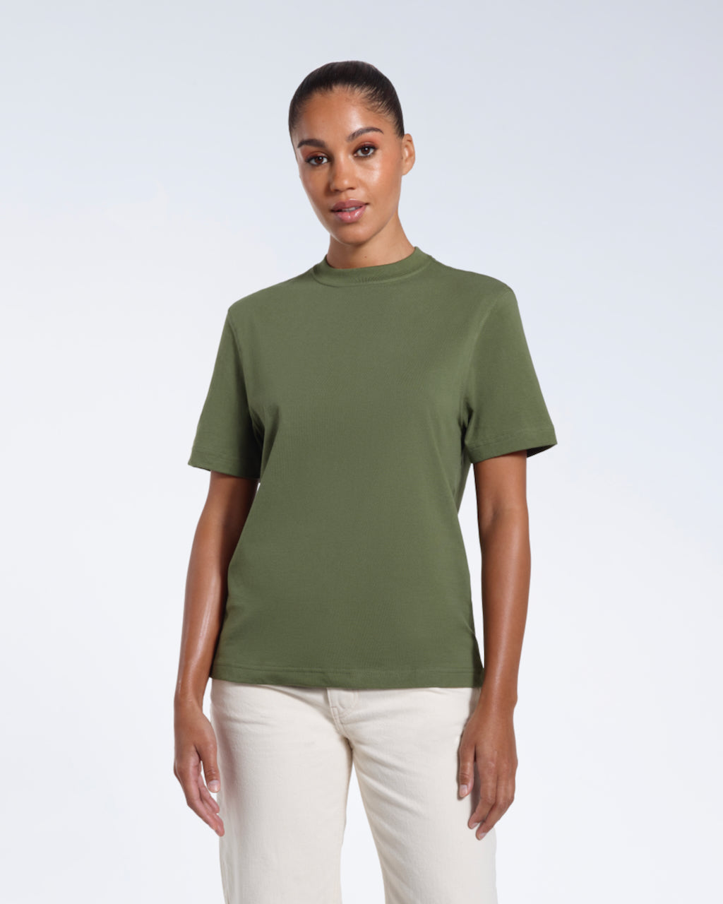 A woman facing front on looking at the camera, modelling a khaki green short sleeve organic cotton t shirt.