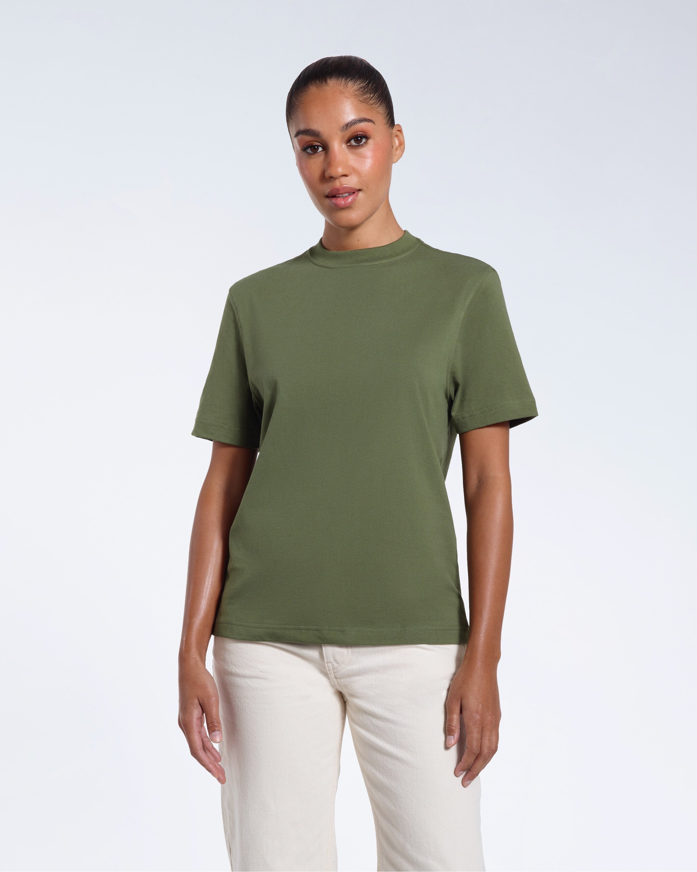 A woman facing front on looking at the camera, modelling a khaki green short sleeve organic cotton t shirt.