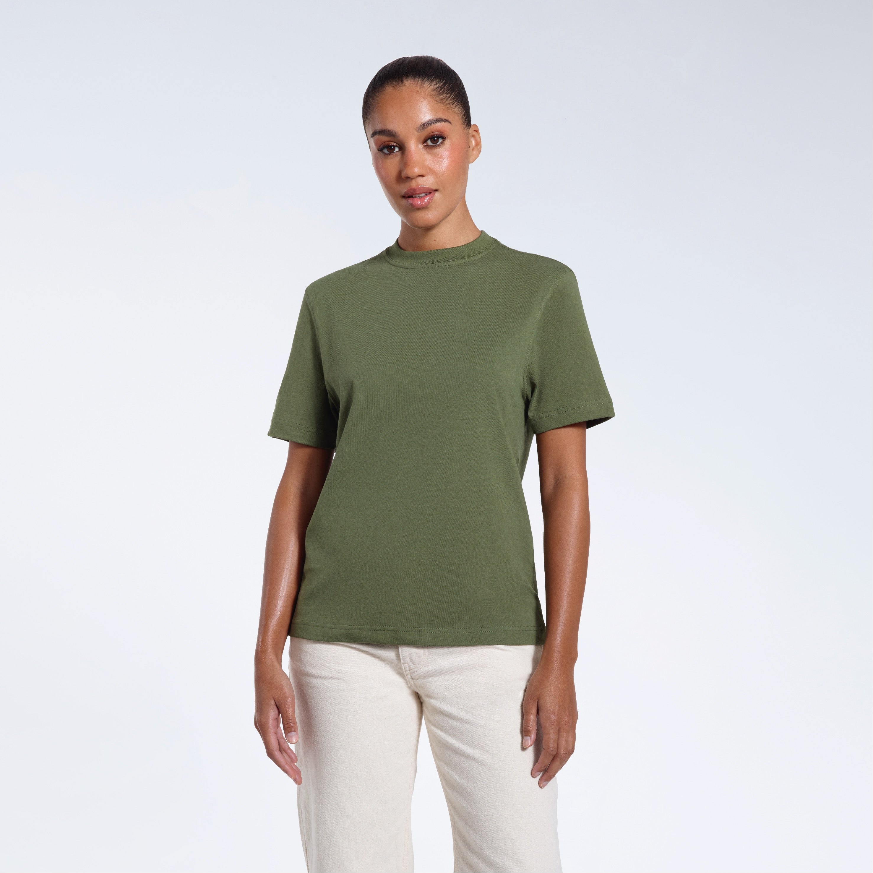 A woman facing front on looking at the camera, modelling a khaki green short sleeve organic cotton t shirt.