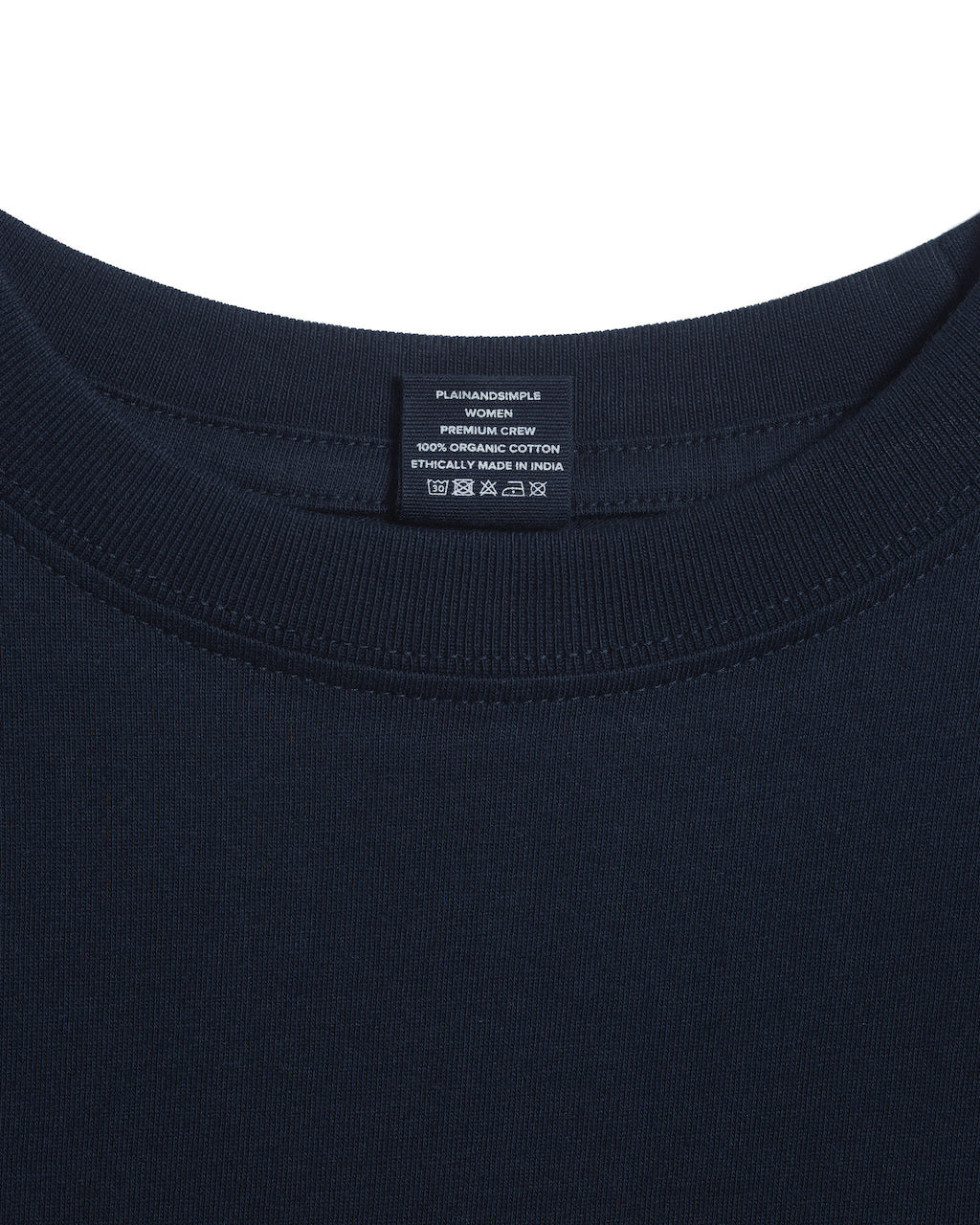 A close up of an neck label in a women's navy short sleeve crew neck organic cotton t shirt.