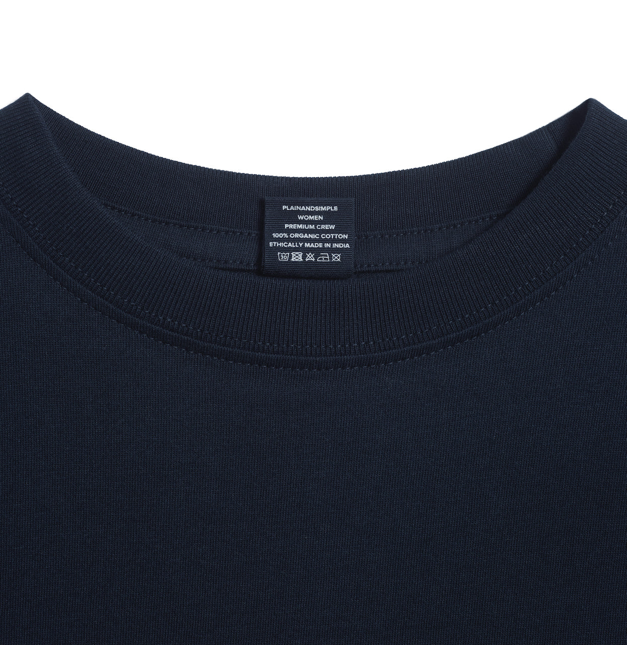 A close up of an neck label in a women's navy short sleeve crew neck organic cotton t shirt.