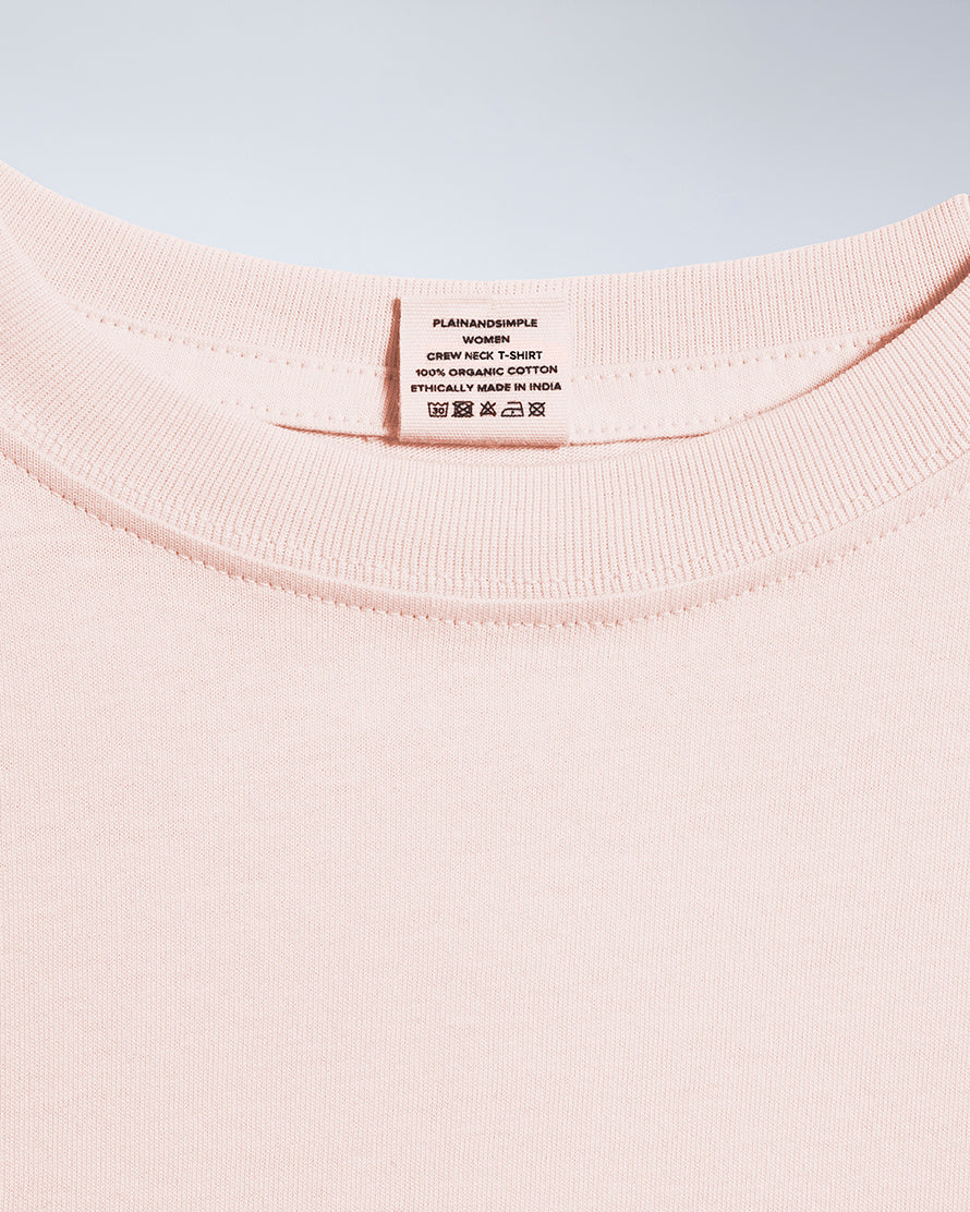 A close up of an neck label in a women's pink short sleeve crew neck organic cotton t shirt.