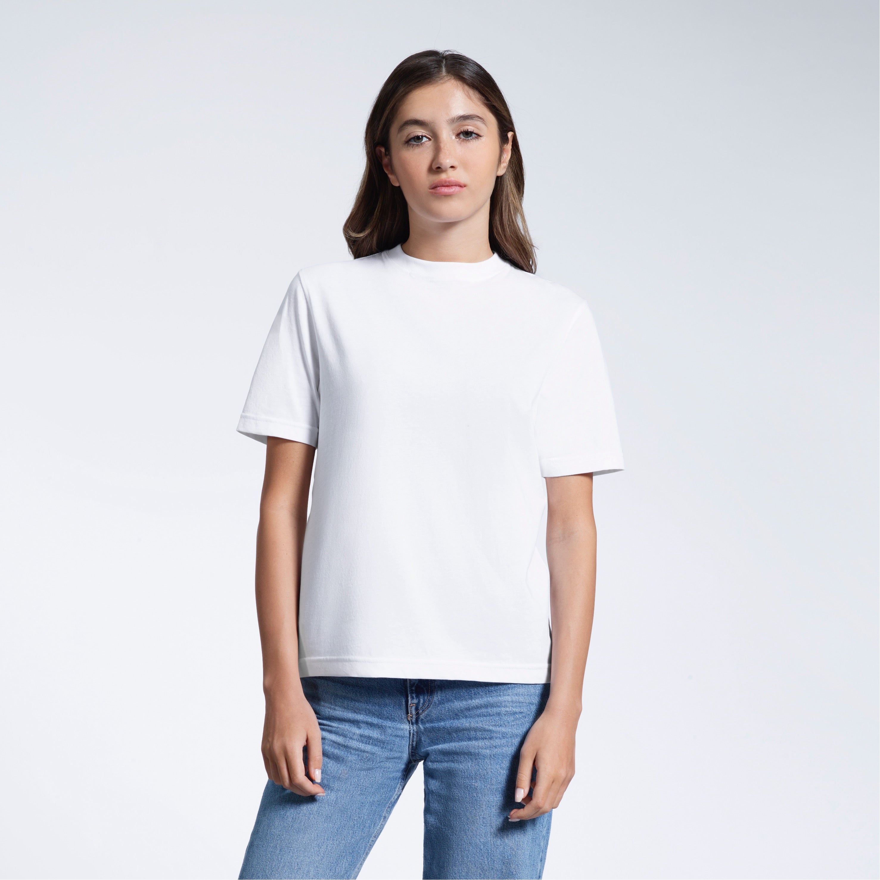 A woman facing front on looking at the camera, modelling a white short sleeve organic cotton t shirt.