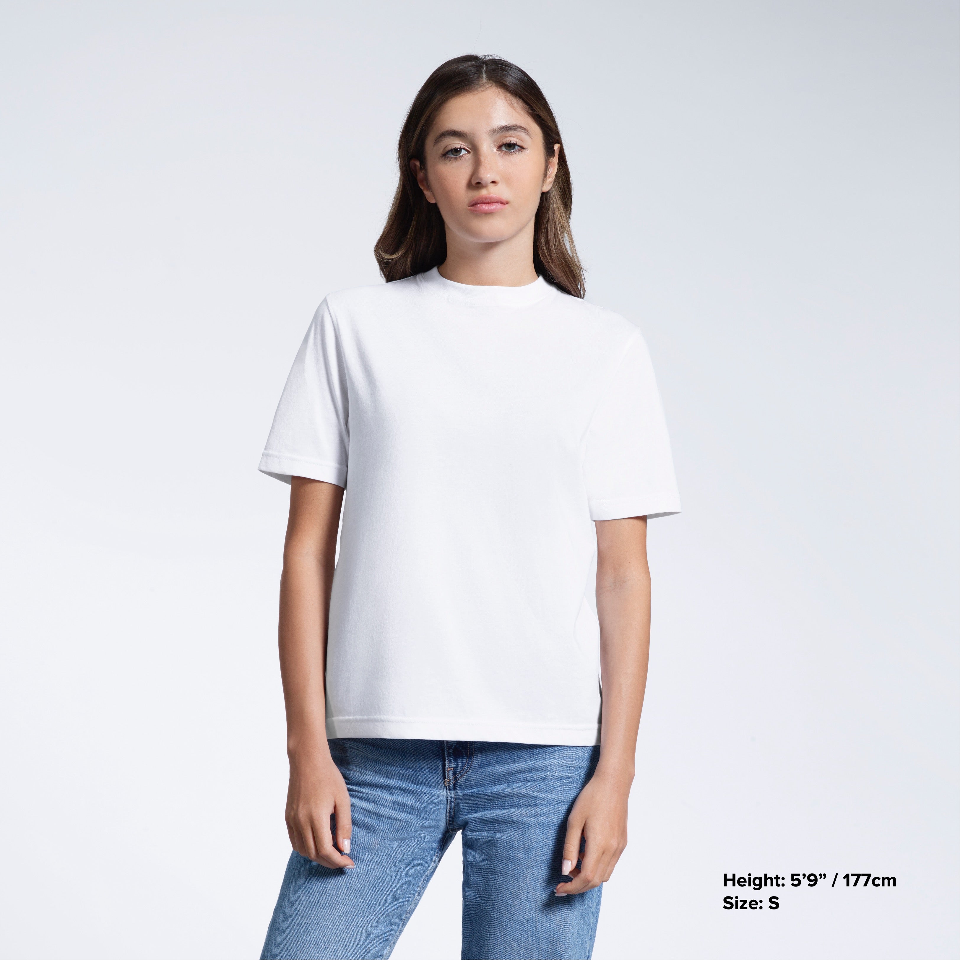 A woman facing front on looking at the camera, modelling a white short sleeve organic cotton t shirt.