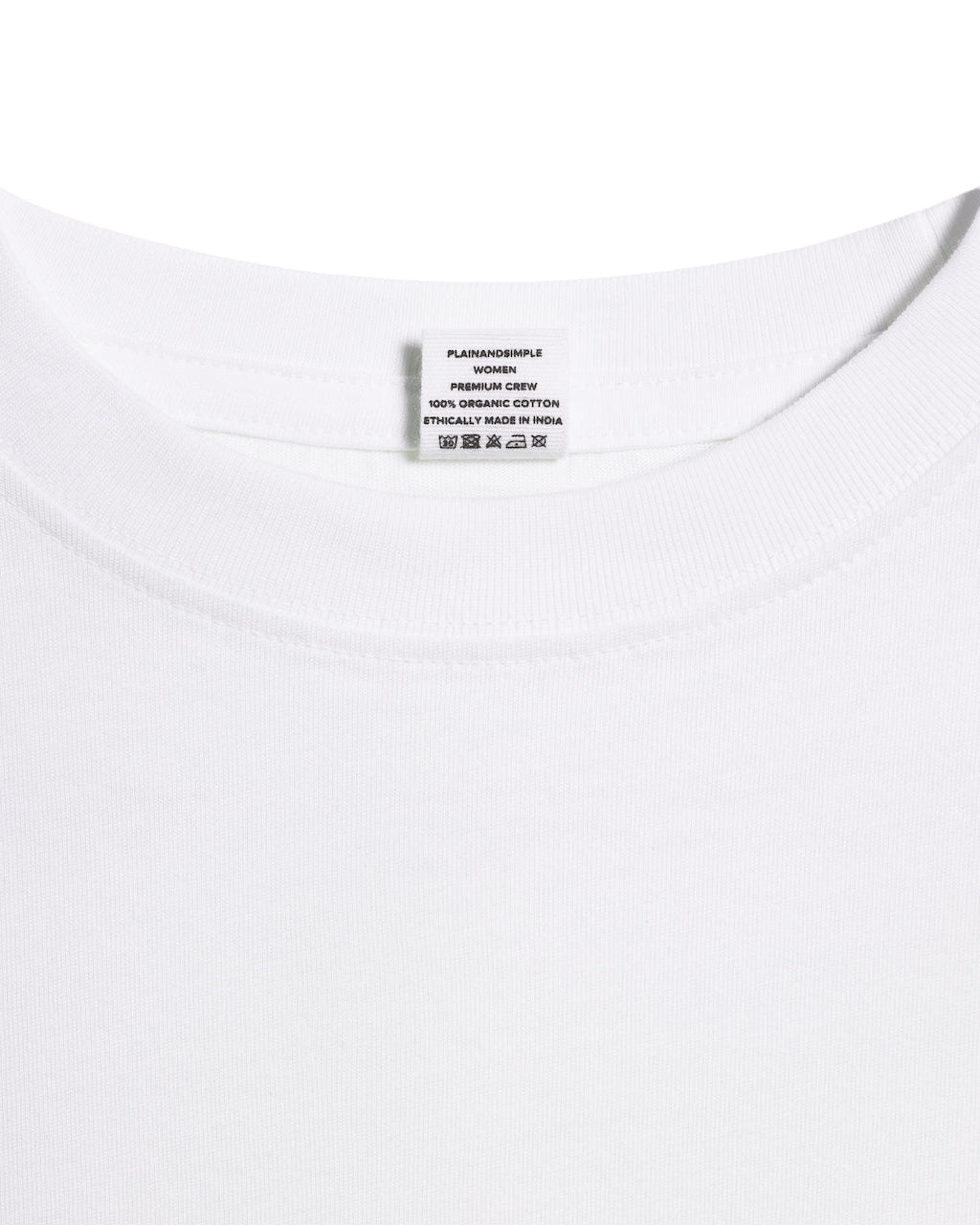 A close up of an neck label in a women's white short sleeve crew neck organic cotton t shirt.