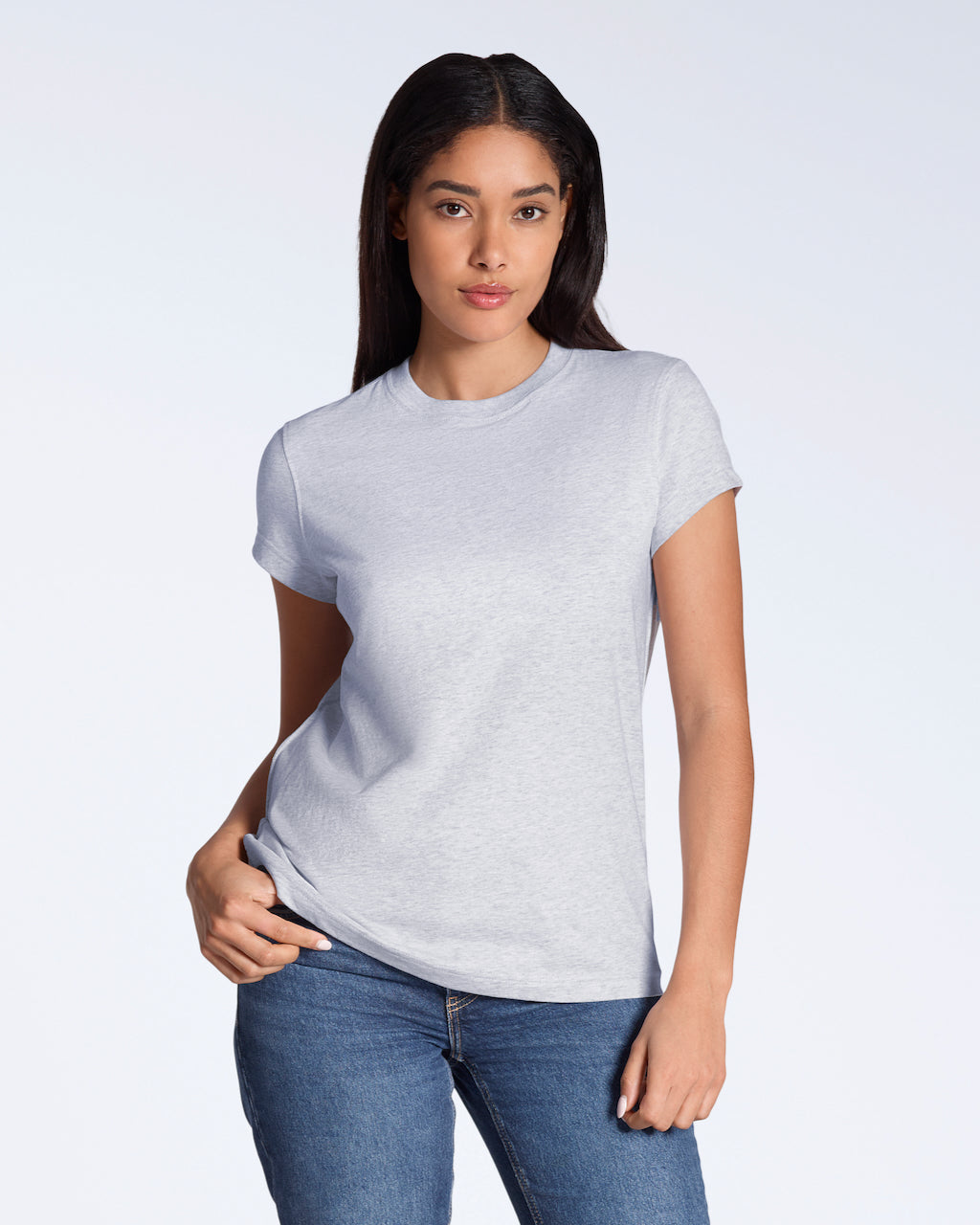 A woman looking into the camera with her hand on her hip, modelling a plain grey, organic cotton t shirt.