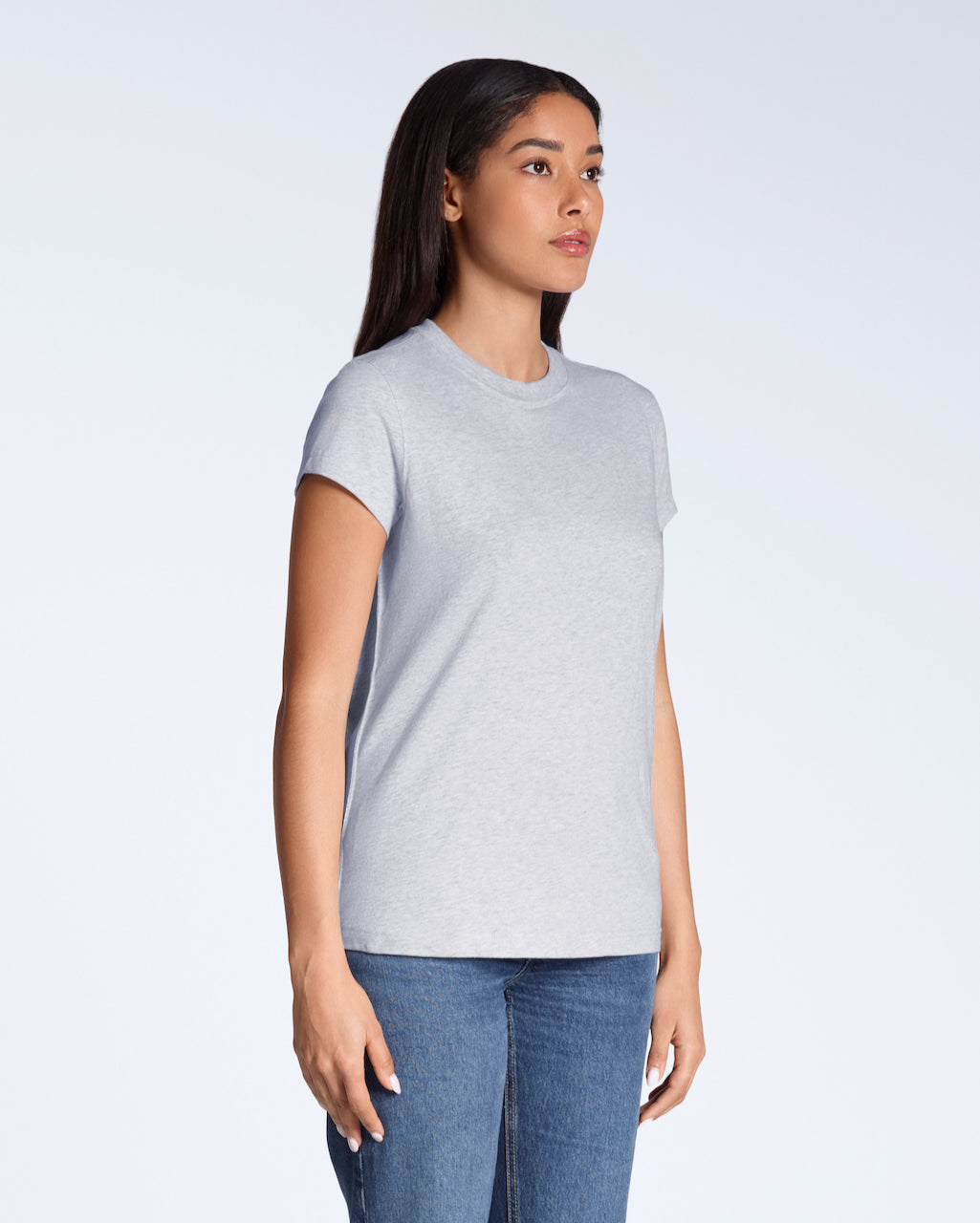 A woman at an angle with her arms by her sides, modelling a plain grey, short sleeve organic cotton t shirt.