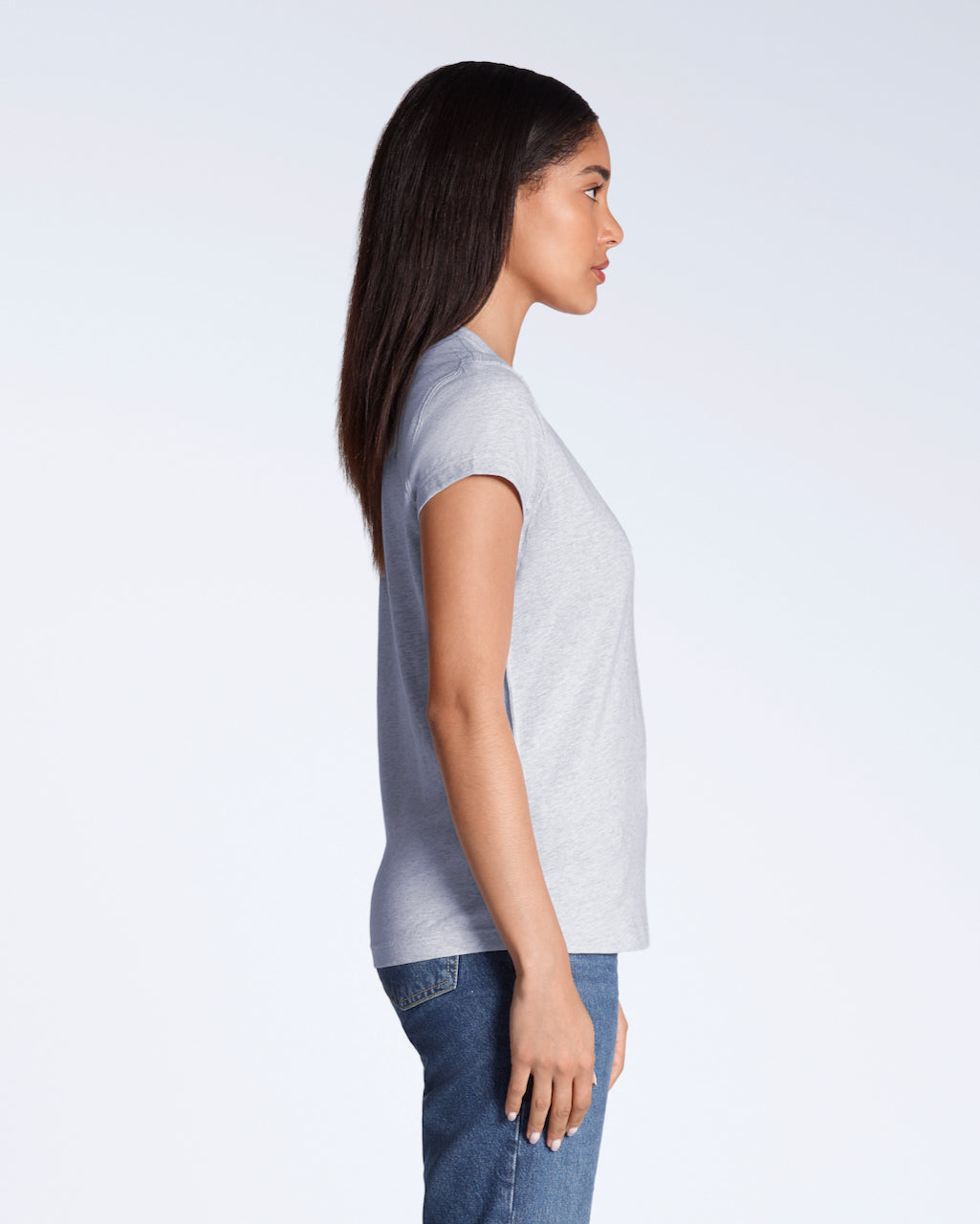 A woman facing side on, modelling a plain grey, short sleeve organic cotton t shirt.