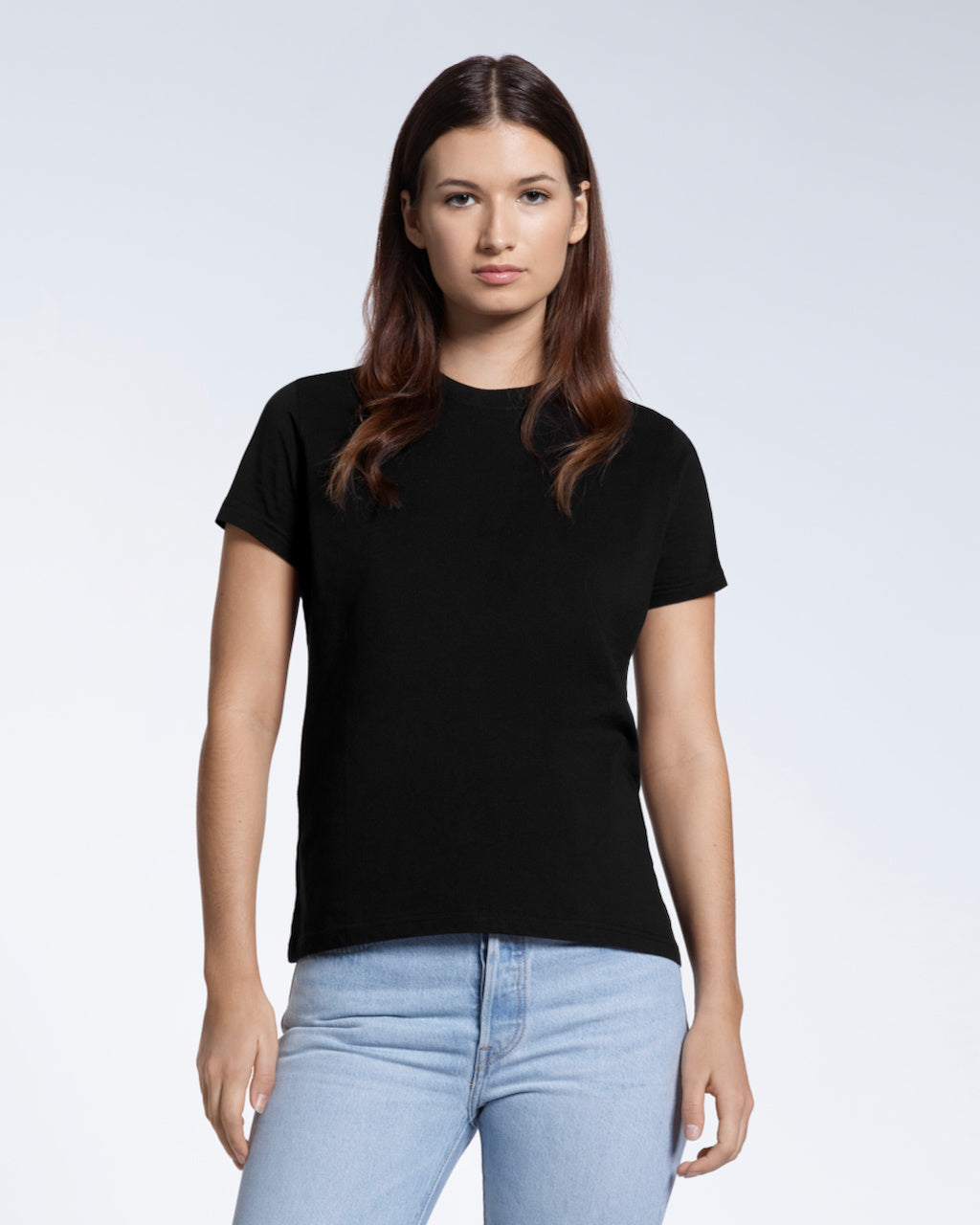 A woman facing front on looking into the camera, modelling a plain black short sleeve organic cotton t shirt.