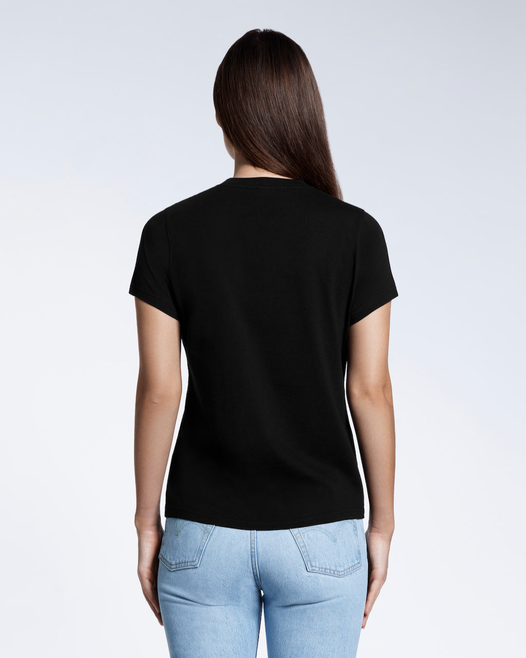 A woman with her back to the camera, modelling a plain black short sleeve organic cotton t shirt.