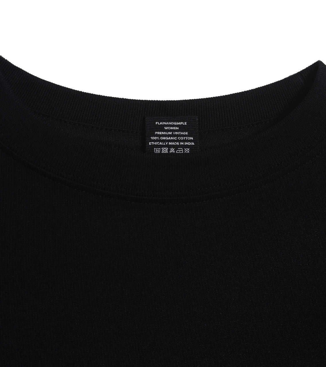 A close up of an neck label in a women's black short sleeve crew neck organic cotton t shirt.