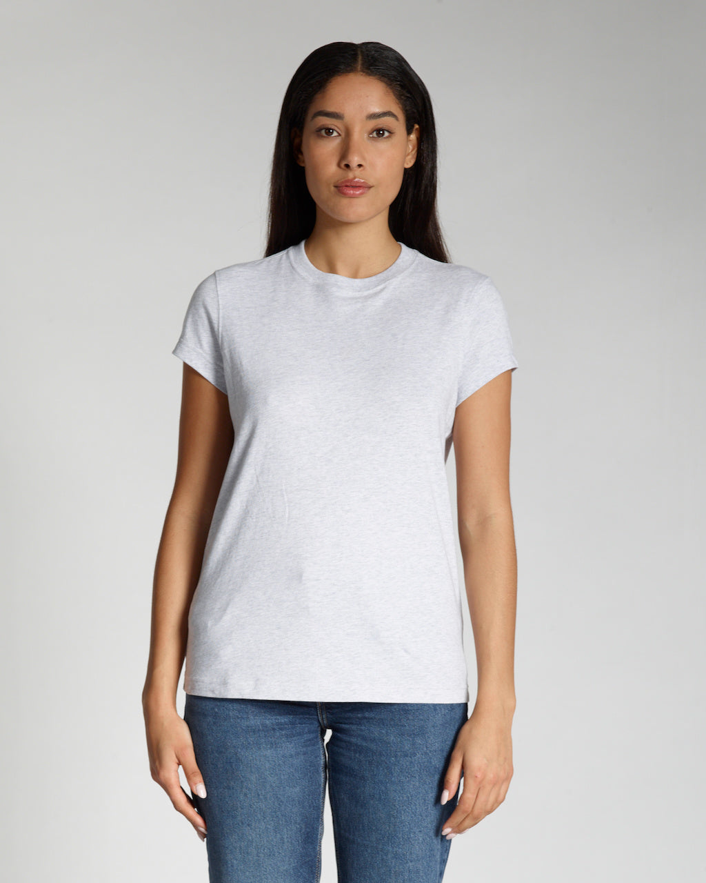 A woman facing front on, modelling a plain grey, short sleeve organic cotton t shirt.