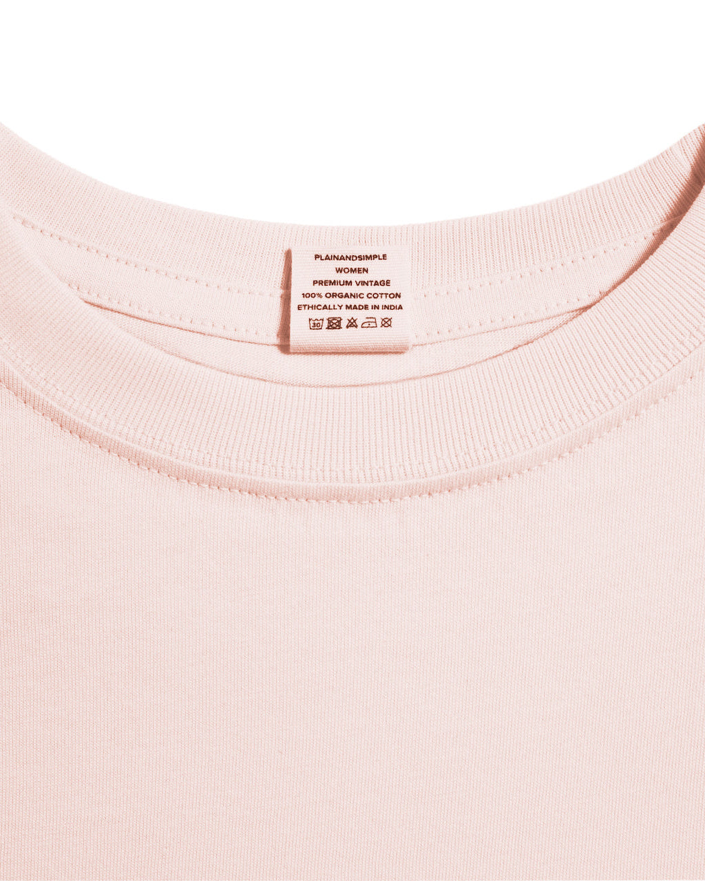 A close up of an neck label in a women's pink short sleeve crew neck organic cotton t shirt.