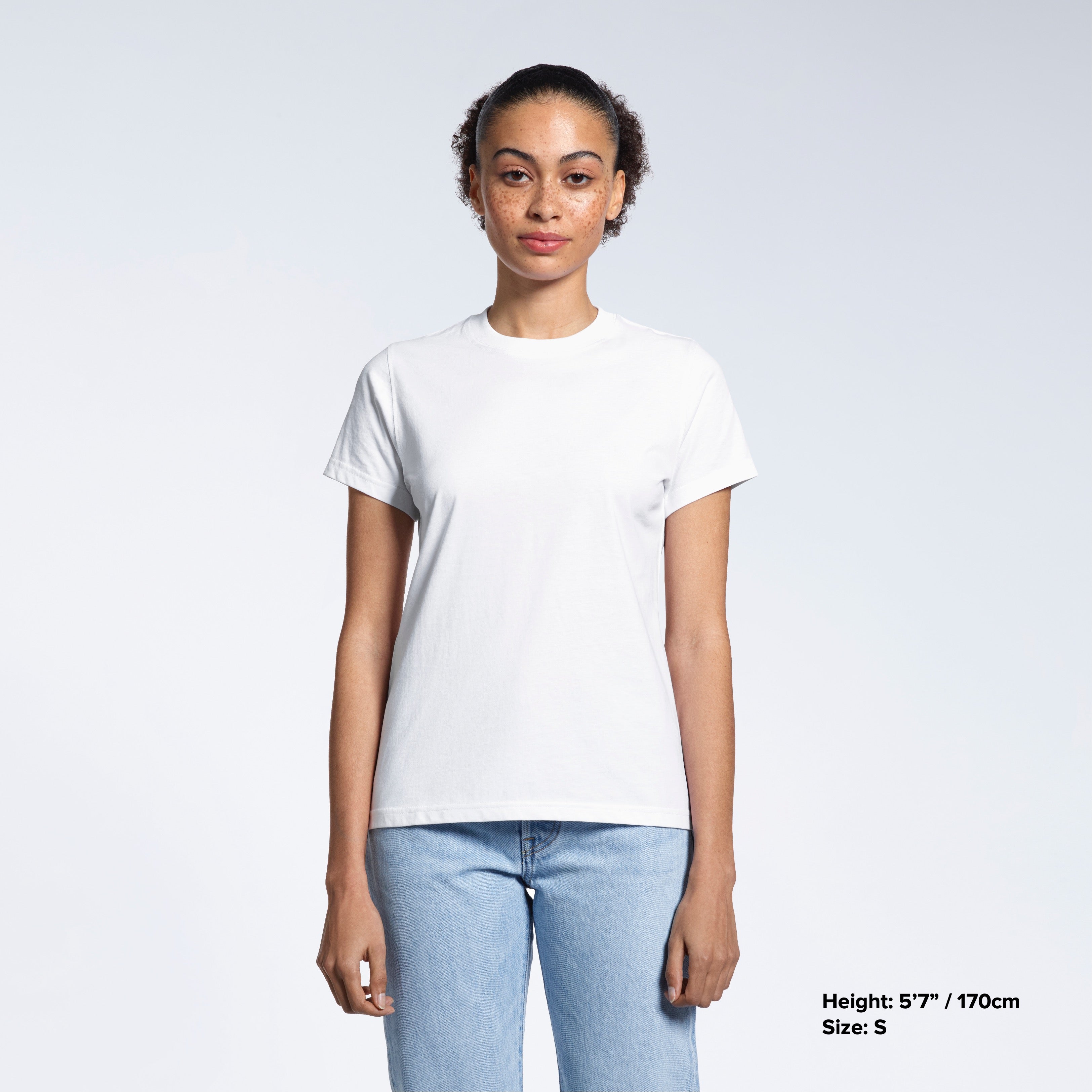 A woman facing front on looking into the camera, modelling a plain white short sleeve organic cotton t shirt.