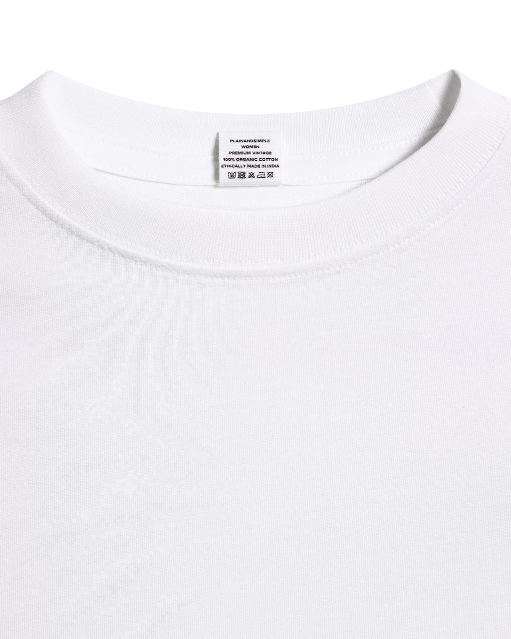 A close up of an neck label in a women's white short sleeve crew neck organic cotton t shirt.