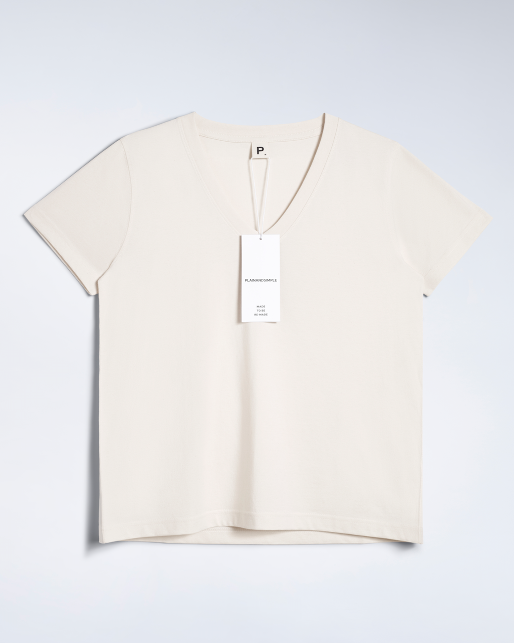 A flatlay of a natural coloured, v neck, organic cotton t shirt.