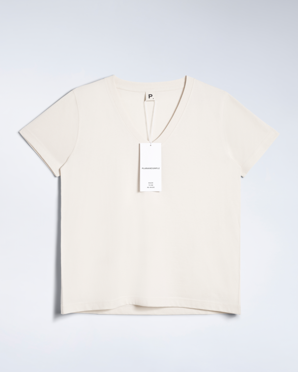 A flatlay of a natural coloured, v neck, organic cotton t shirt.