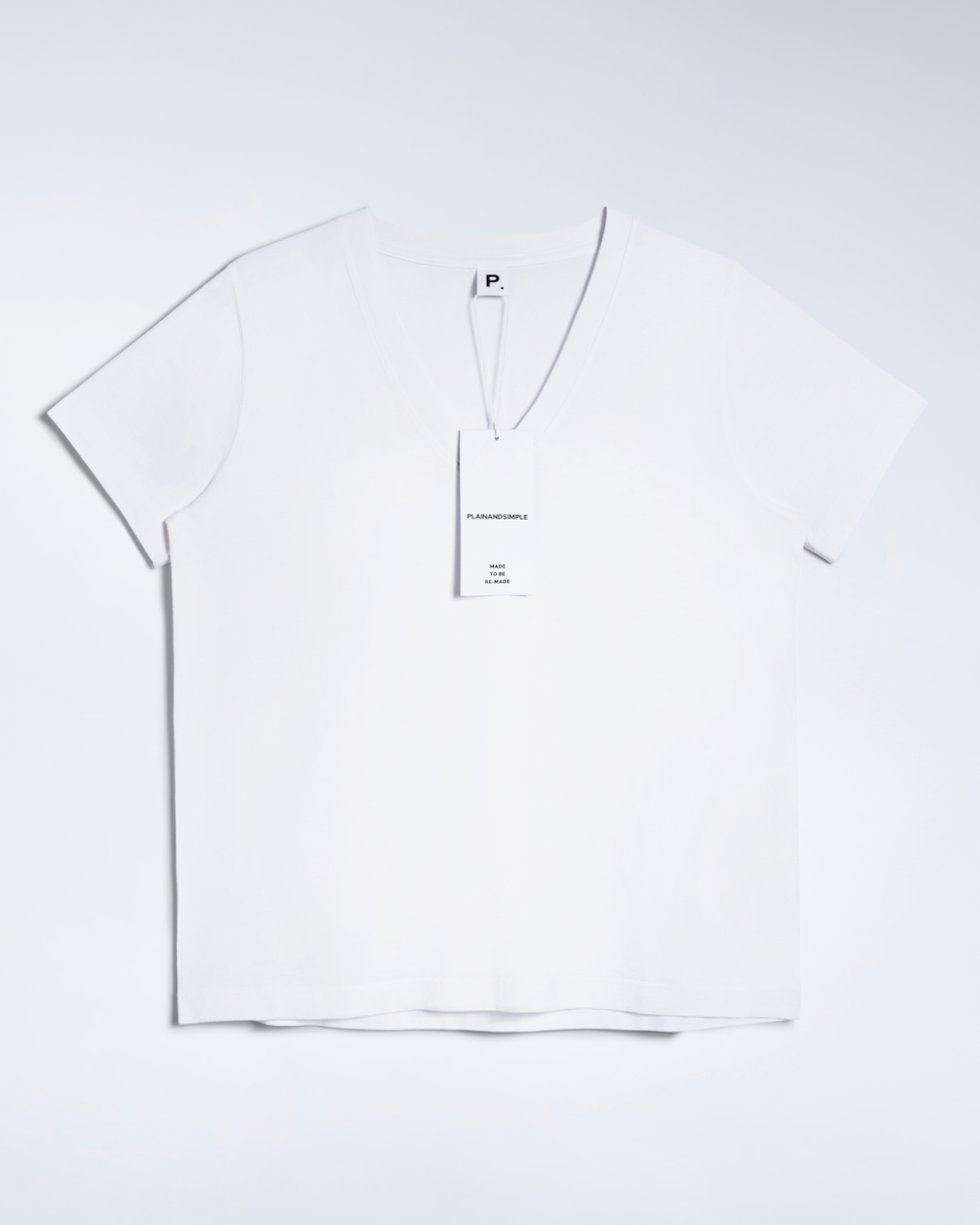 A flatlay of a white, v neck, organic cotton t shirt.