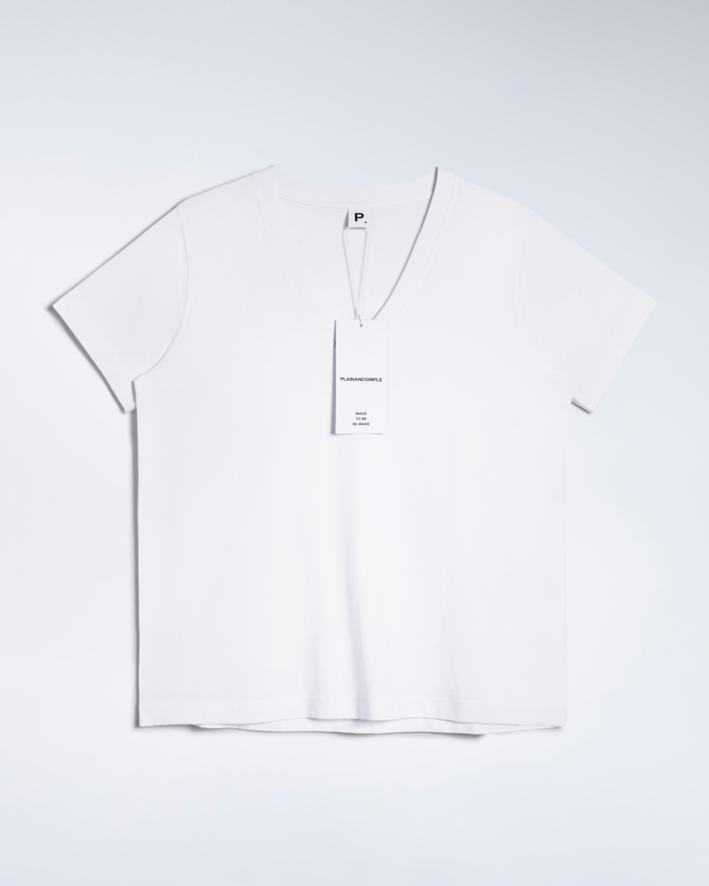 A flatlay of a white, v neck, organic cotton t shirt.