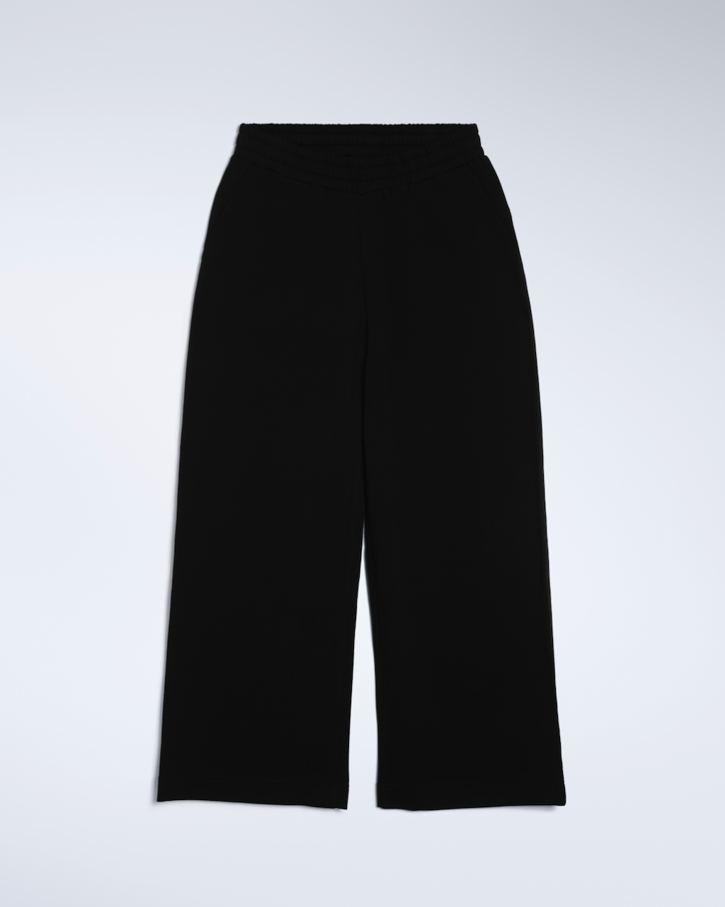 A flatlay of a pair of black, wide leg, organic cotton joggers.
