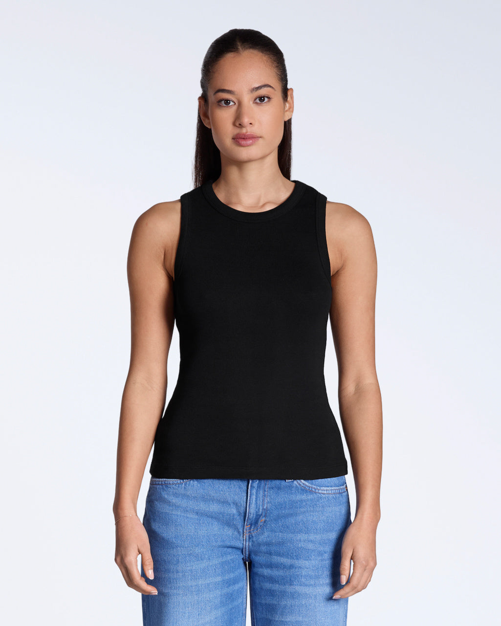 A woman facing front on, modelling a plain black, organic cotton tank top.