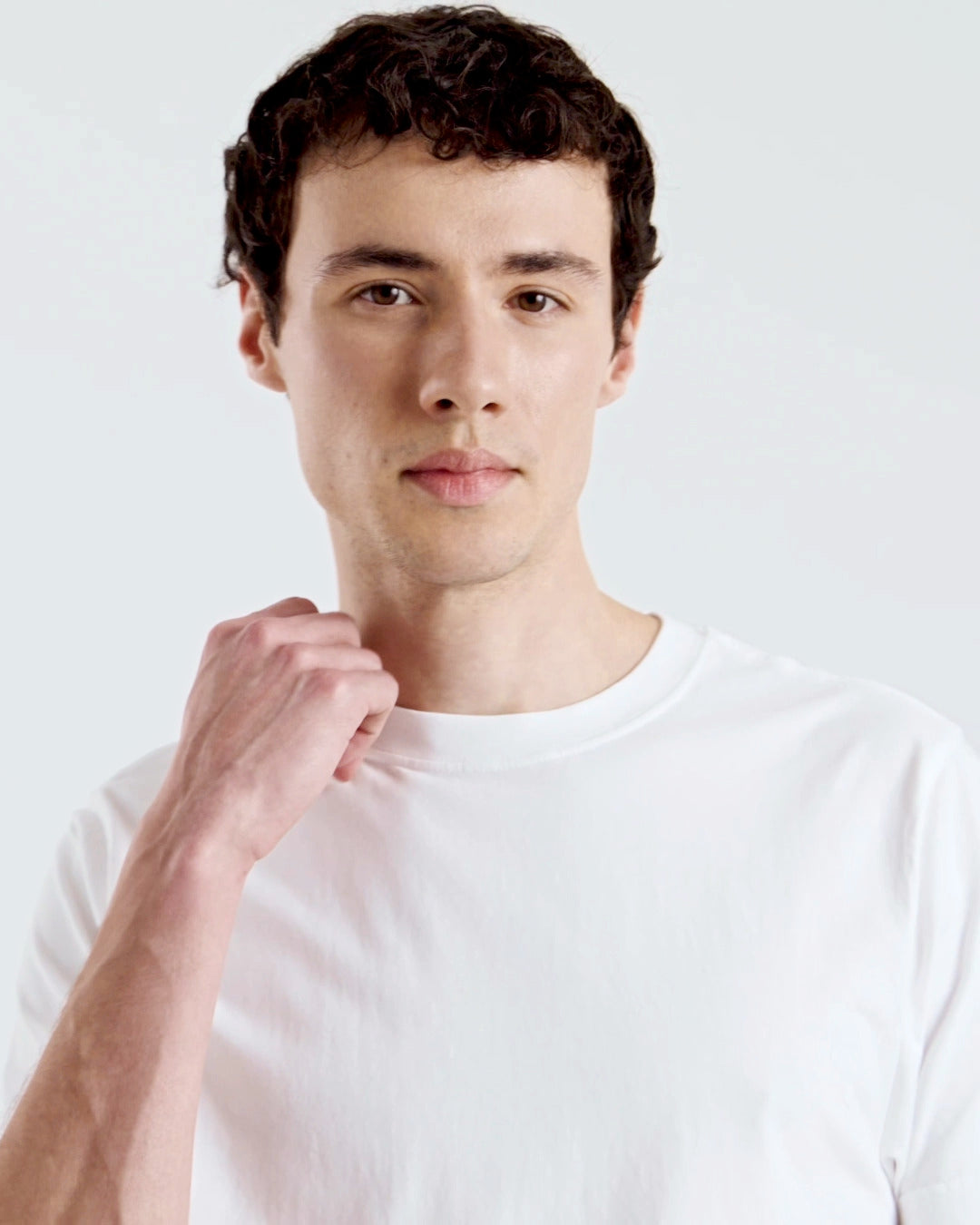 A compilation of short video clips of a man modelling a plain white, organic cotton t shirt with a pair of jeans.